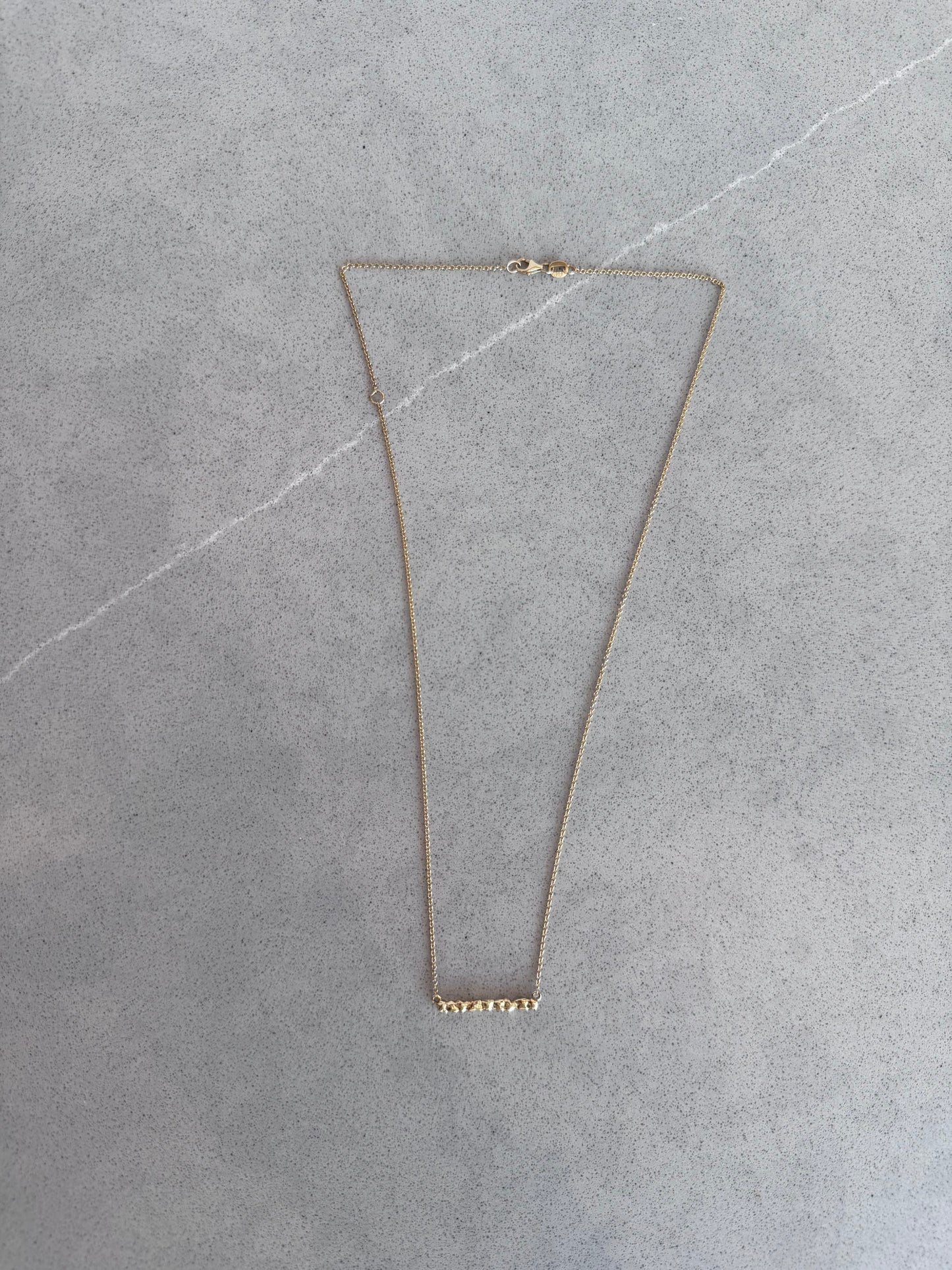 Close up 14 karat gold bar necklace by BlaireBe Jewelry