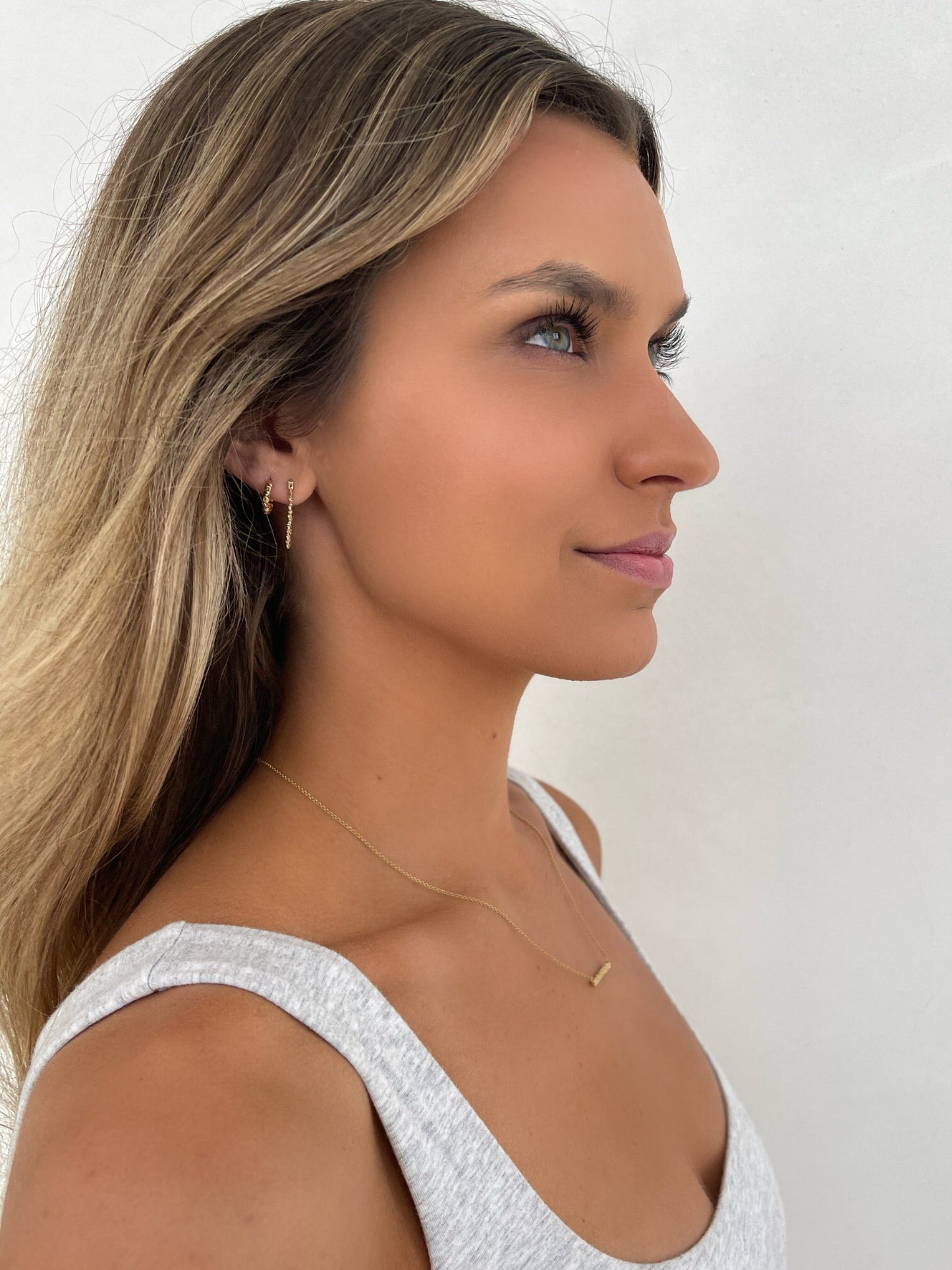 Side view 14 karat gold mini hoop earrings by BlaireBe Jewelry