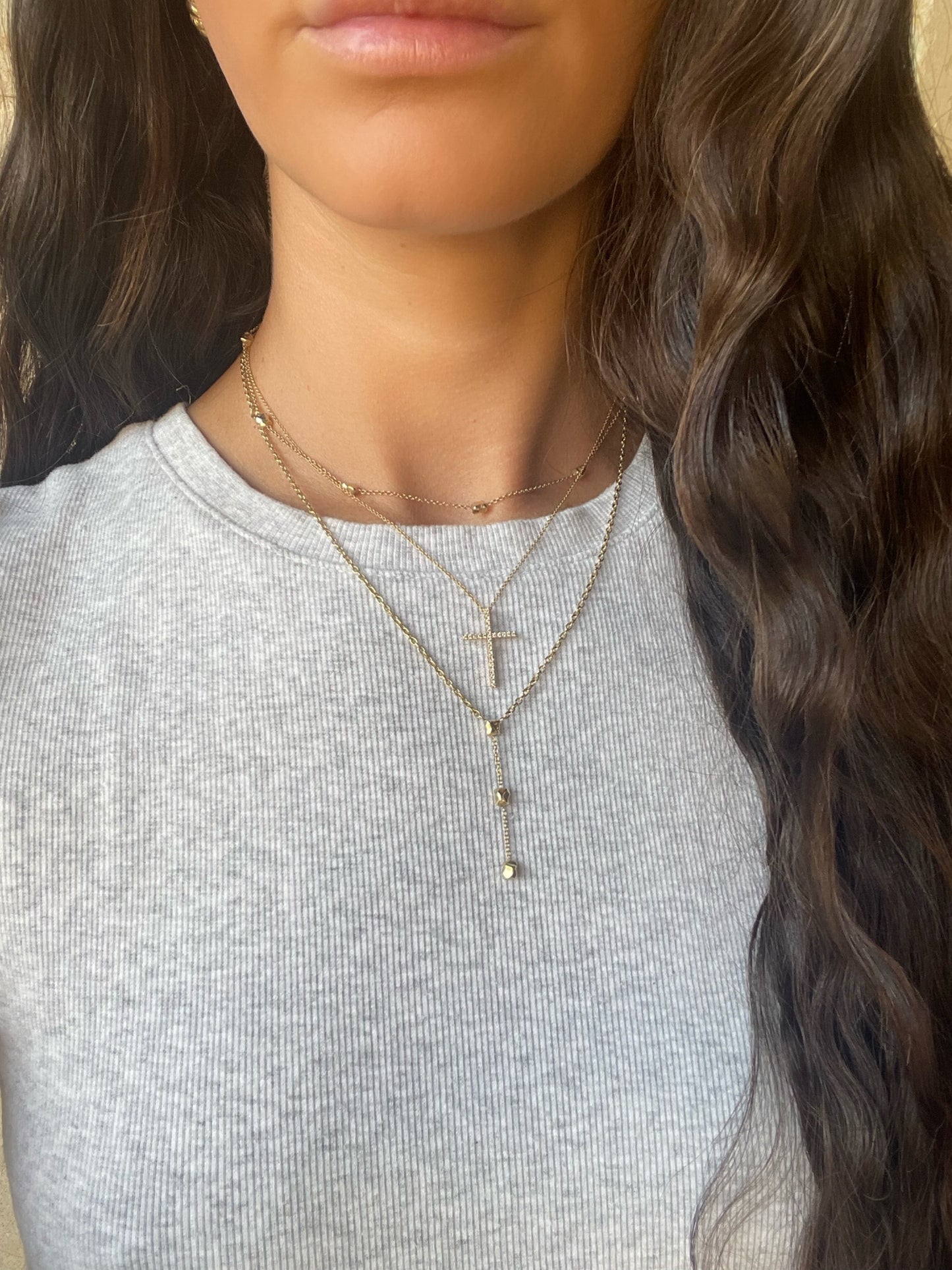 14 karat gold lab-grown diamond cross necklace on model by BlaireBe Jewelry
