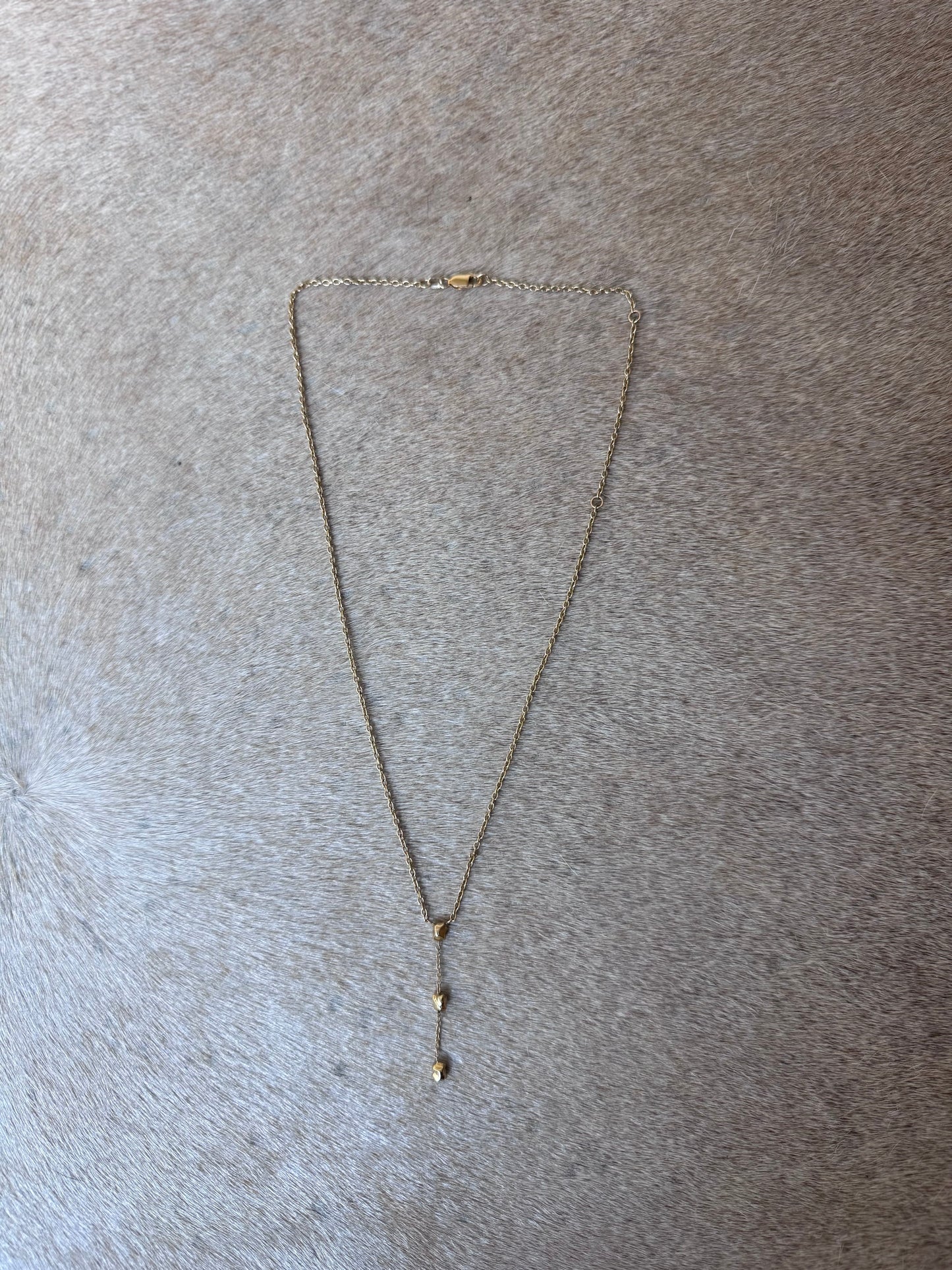 Detail shot 14 karat gold nugget necklace on model by BlaireBe Jewelry