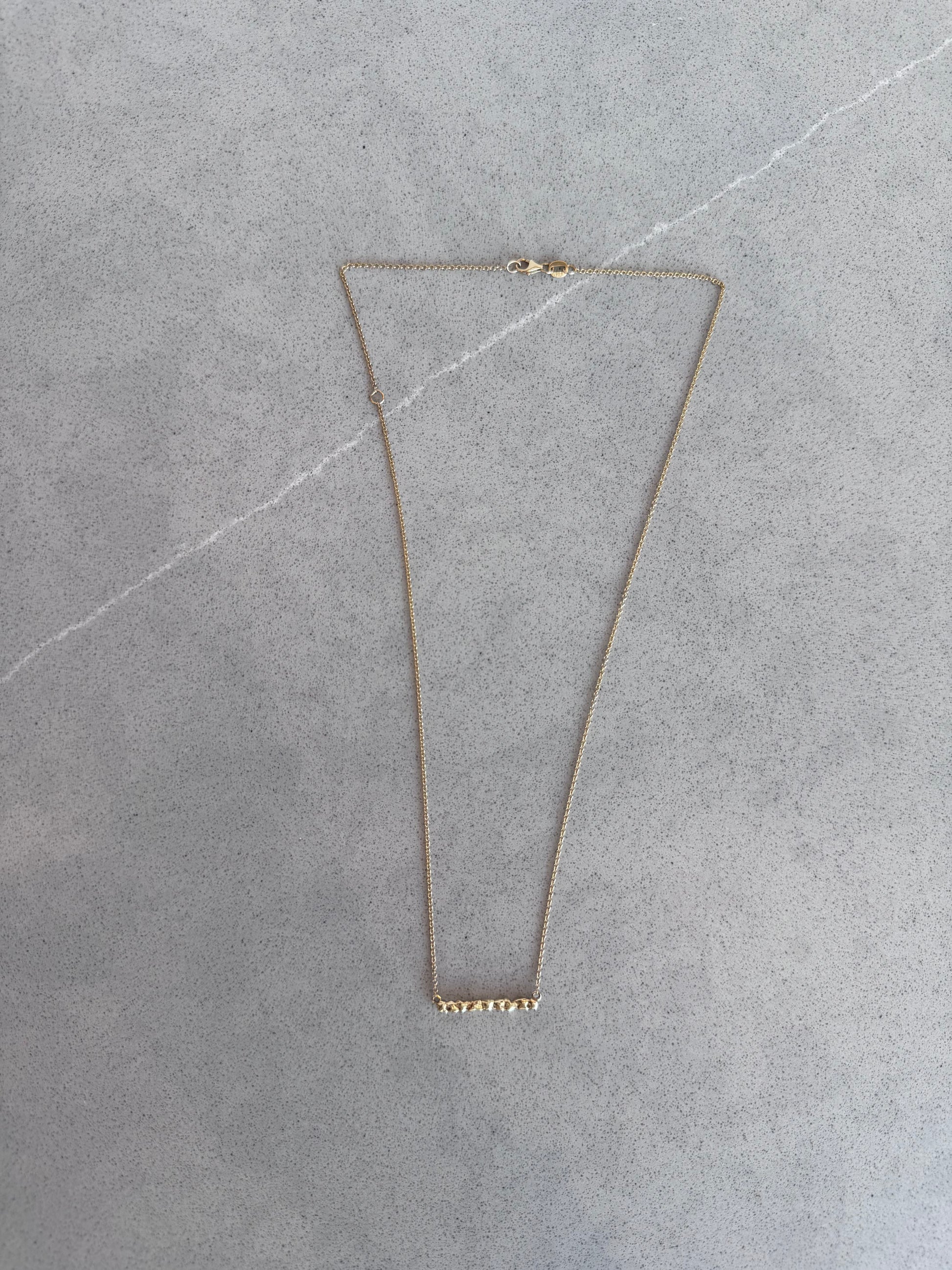 Close up 14 karat gold bar necklace by BlaireBe Jewelry