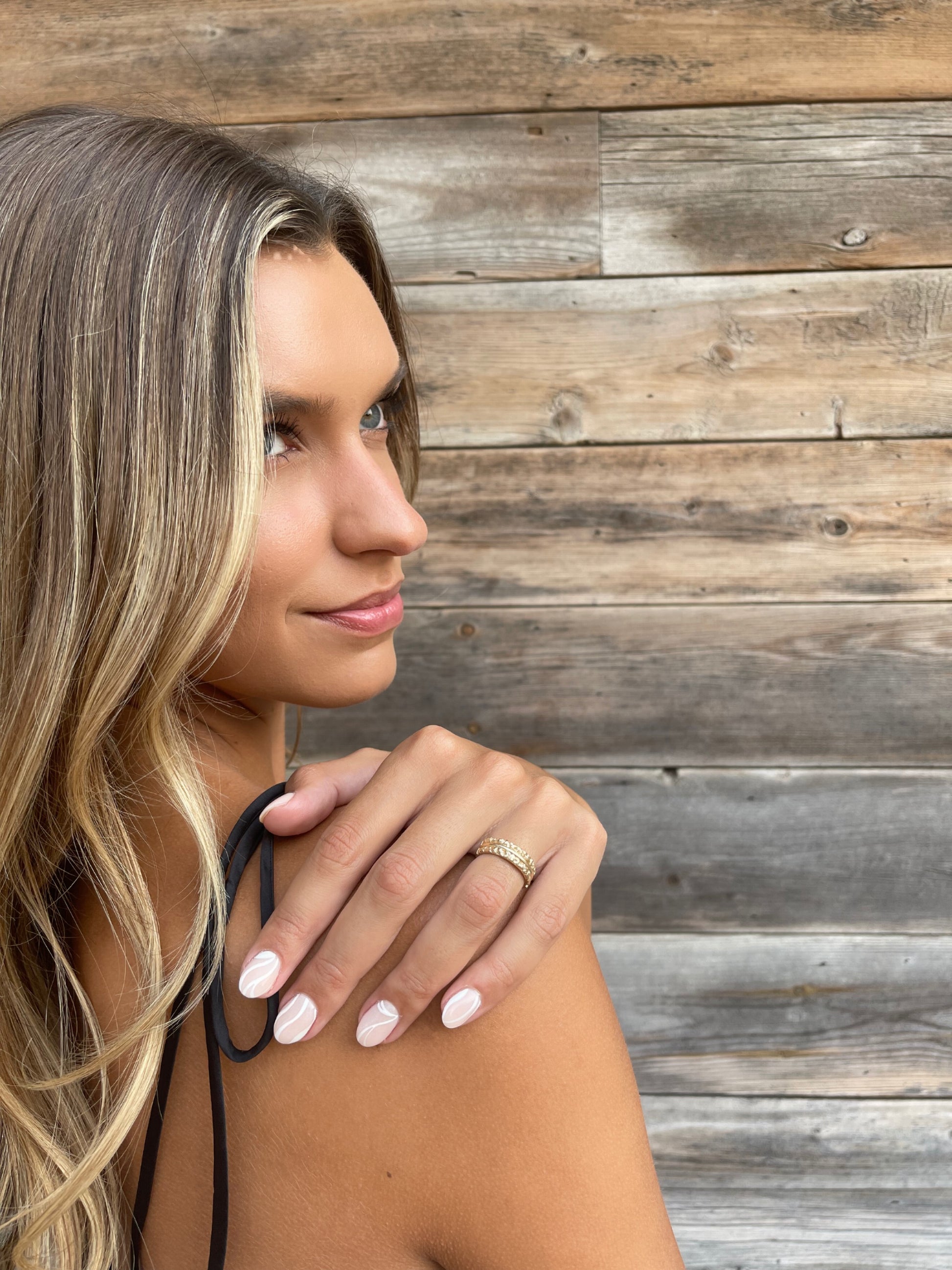 14 karat gold textured band ring on model by BlaireBe Jewelry